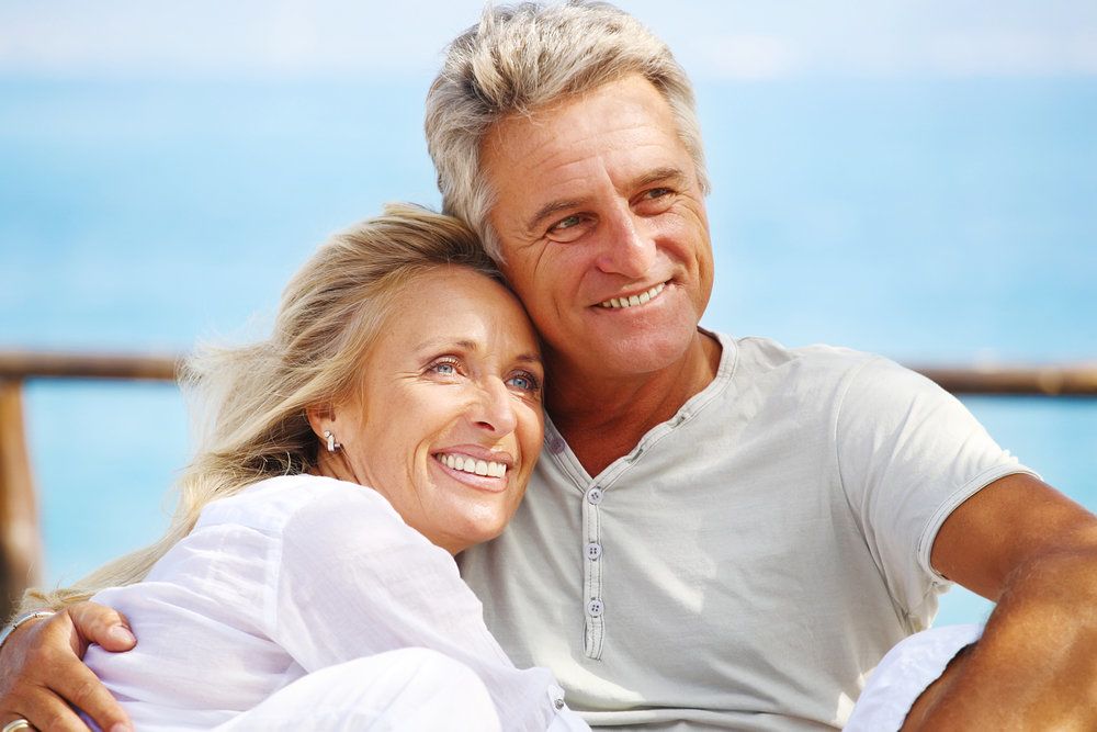 Middle-aged couple contentedly hugging each other